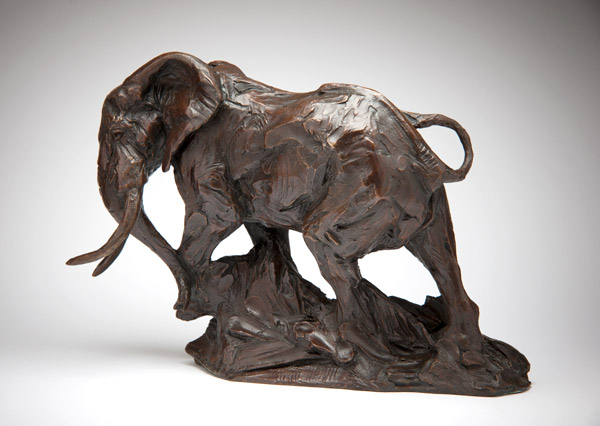 Bronze sculpture of an elephant walking with detailed textures on a base.